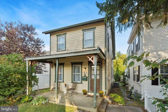 front view of a house with a tree