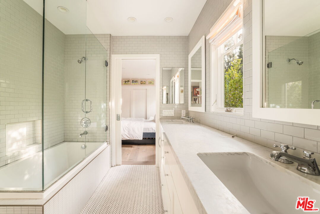 9617 Kirkside Road Los Angeles, CA 90035 - Photo 12 of 14 a spacious bathroom with a tub shower and sink