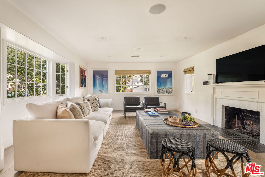 9617 Kirkside Road Los Angeles, CA 90035 - Photo 3 of 14 a living room with fireplace furniture and a flat screen tv