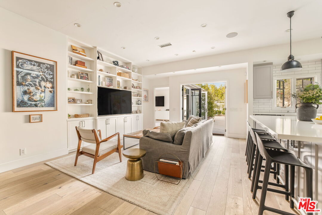 9617 Kirkside Road Los Angeles, CA 90035 - Photo 7 of 14 a living room with furniture a flat screen tv and a dining table