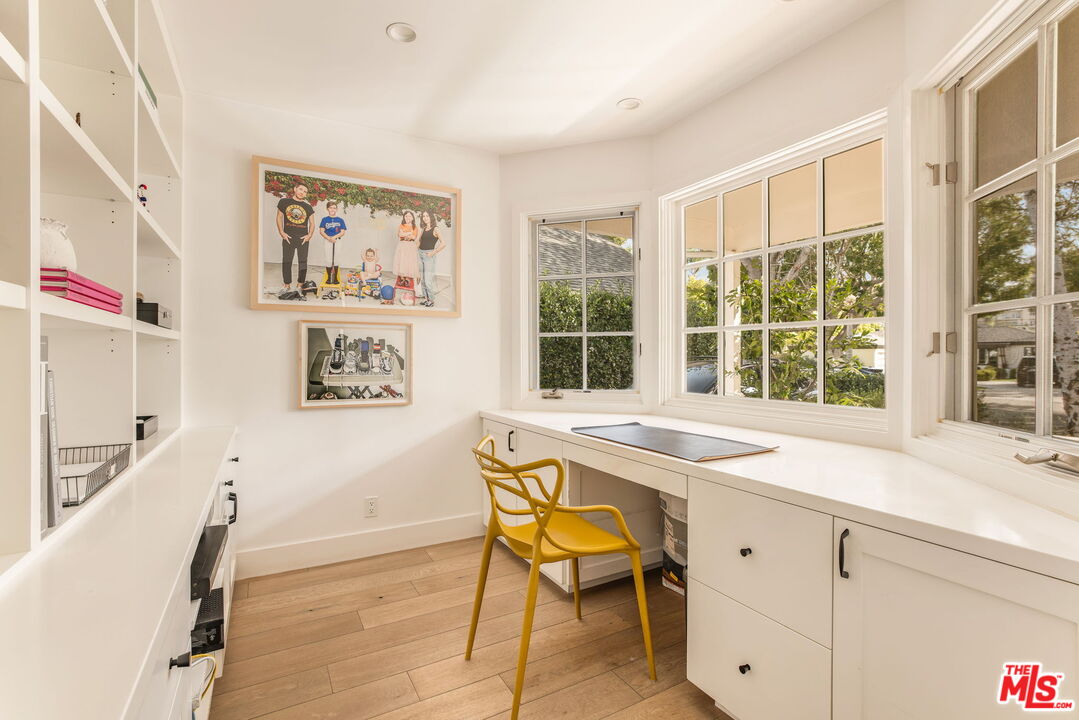 9617 Kirkside Road Los Angeles, CA 90035 - Photo 8 of 14 a table and chair sitting in a room with a window