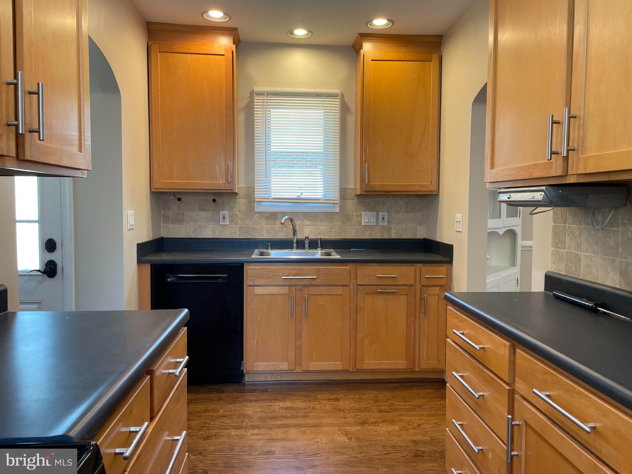 922 Overbrook Road Baltimore, MD 21239 - Photo 5 of 15 a kitchen with stainless steel appliances granite countertop a sink a stove and a microwave