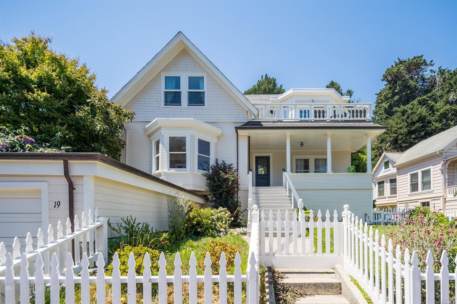 a view of a house with wooden fence