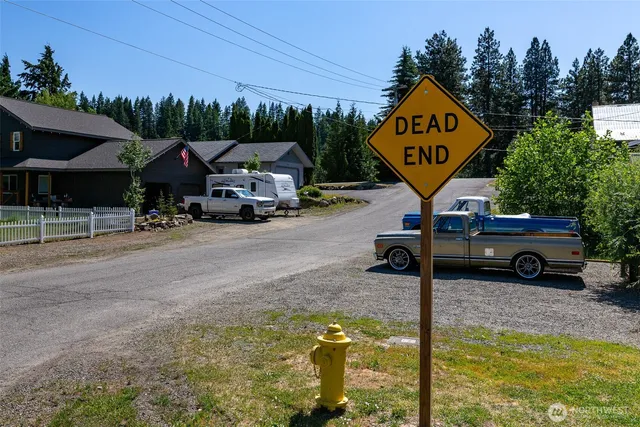 a view of a street with cars parked in front of it