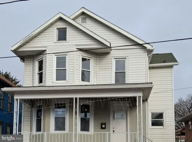 a view of a white house with large windows