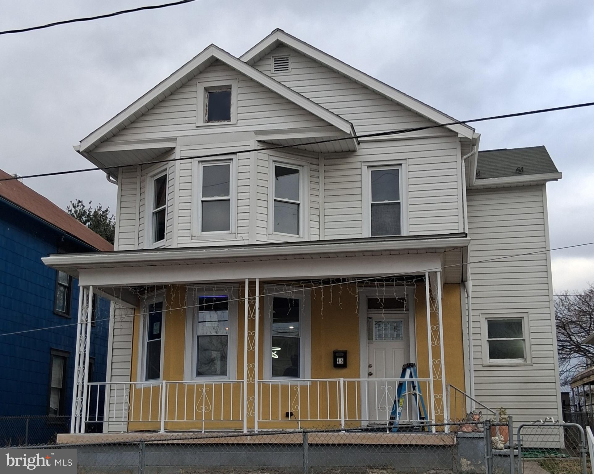 Charming two-story home with vibrant accents.