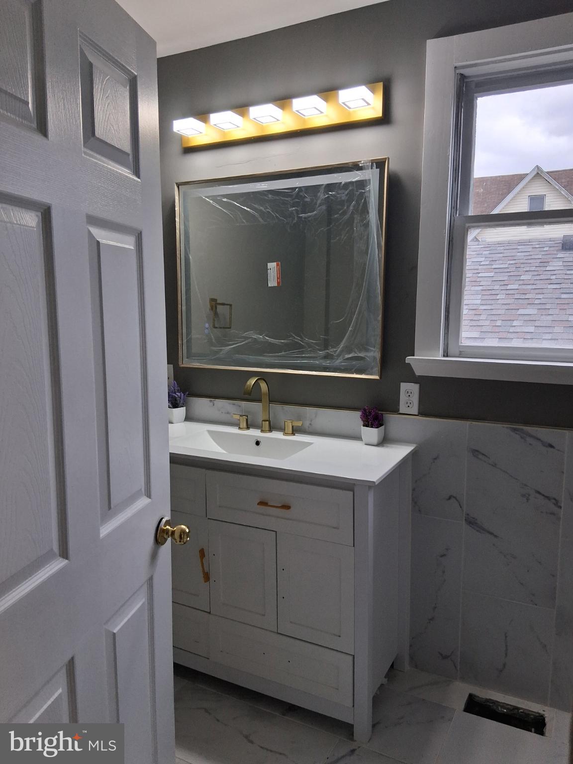 46 Boone Street Cumberland, MD 21502 - Photo 16 of 42 a bathroom with a sink vanity and mirror