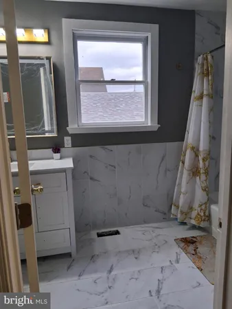 a bathroom with bathtub and shower