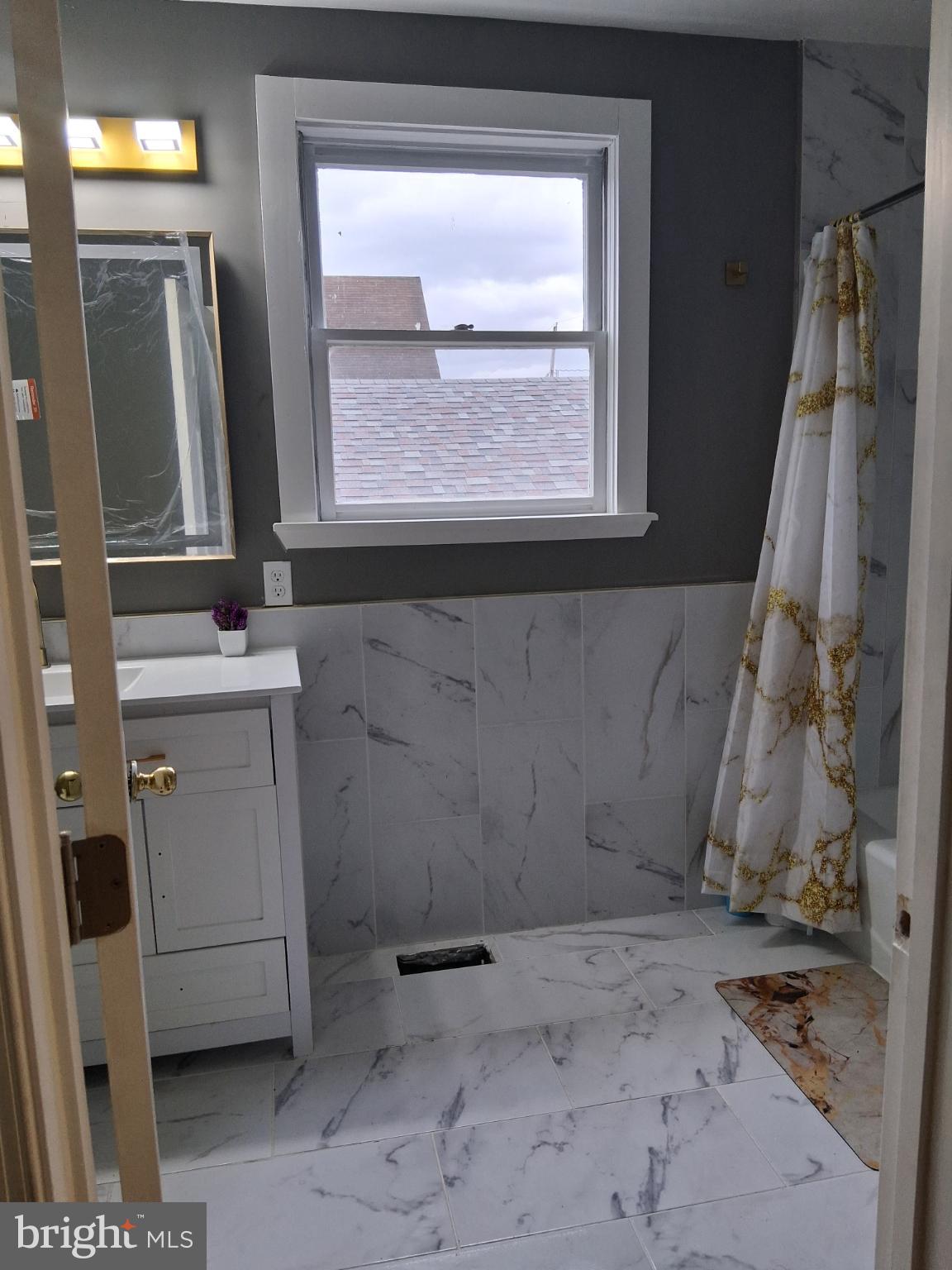 46 Boone Street Cumberland, MD 21502 - Photo 17 of 42 a bathroom with a sink a toilet and a mirror