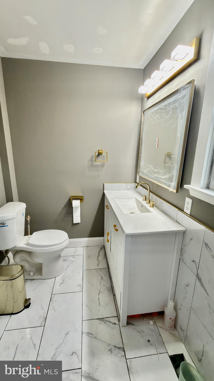 46 Boone Street Cumberland, MD 21502 - Photo 22 of 42 a bathroom with a sink mirror vanity and toilet