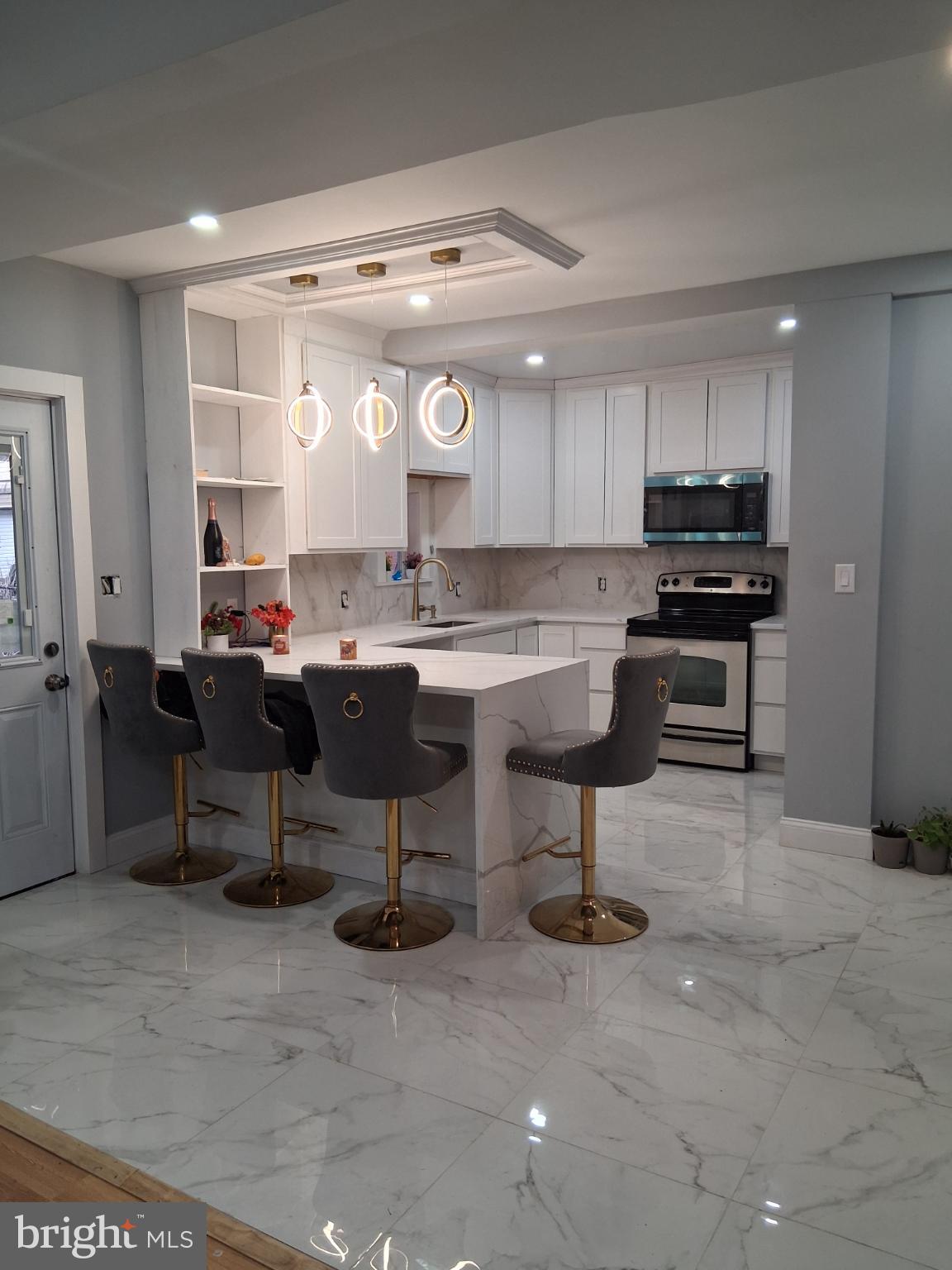 46 Boone Street Cumberland, MD 21502 - Photo 29 of 42 a kitchen with a sink and chairs