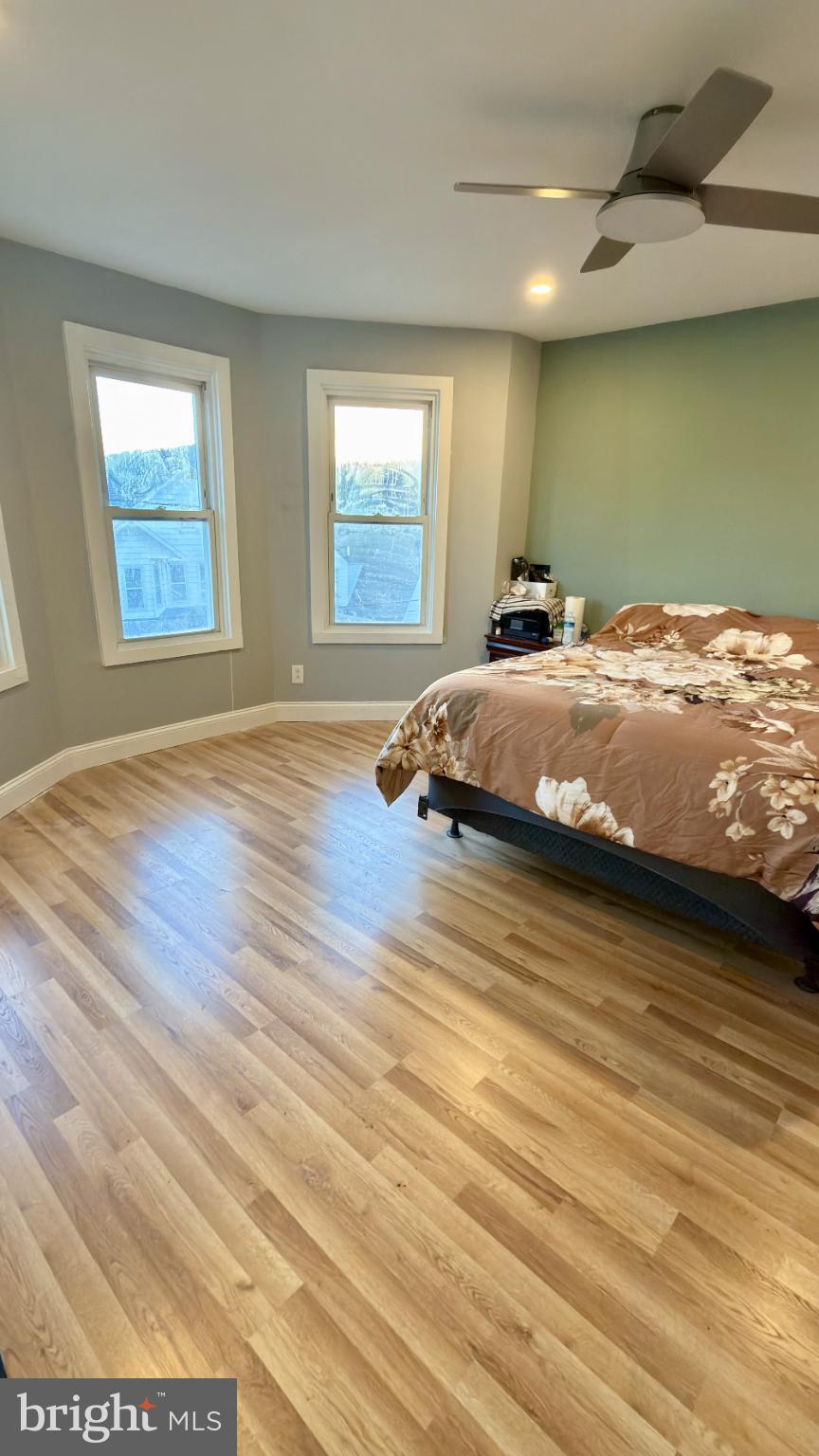 46 Boone Street Cumberland, MD 21502 - Photo 7 of 42 a bedroom with a bed and wooden floor