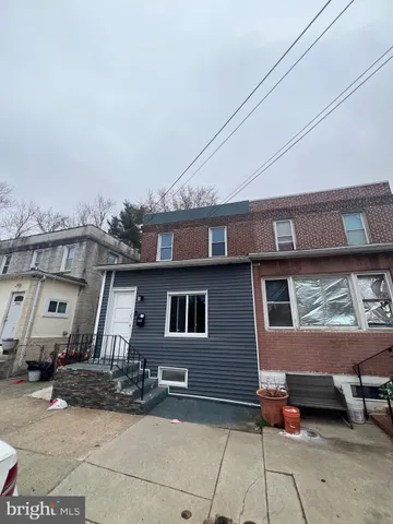 a front view of a house with outdoor seating