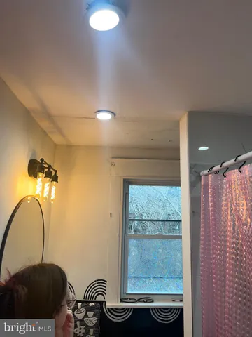 a bedroom with a bed and a mirror