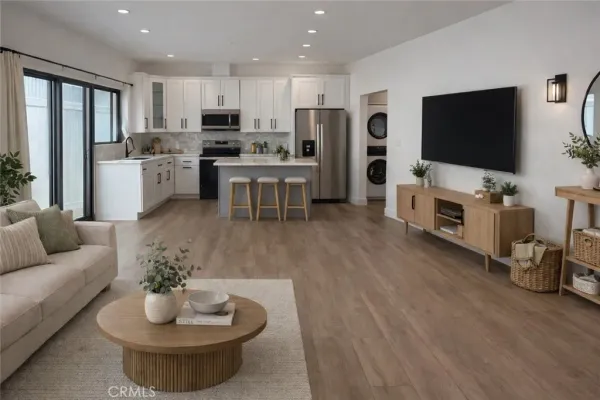 a kitchen with stainless steel appliances a sink stove refrigerator and cabinets