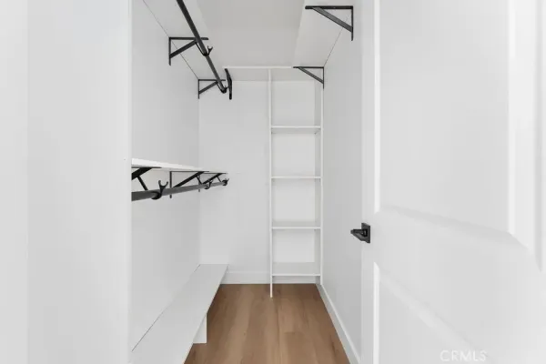 an empty room with mirror and windows
