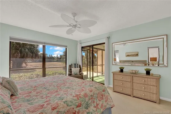 a bedroom with a bed next to a window with outer view