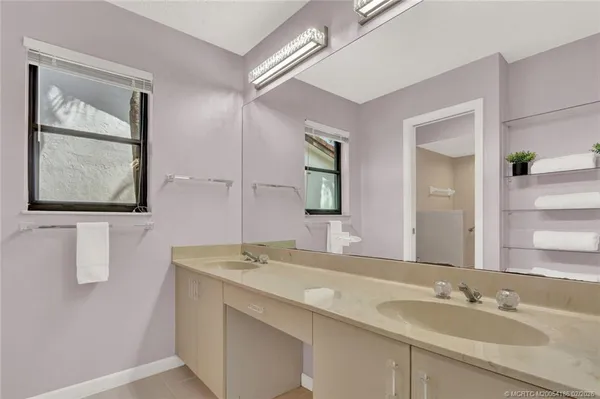 a bathroom with 2 sink and a mirror