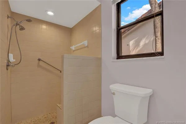 a bathroom with a toilet and a shower