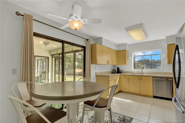 a kitchen with a table chairs and microwave