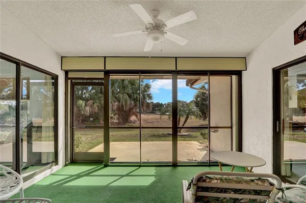 a room with a large window and a rug