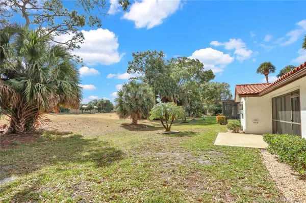 a view of a yard with yellow house