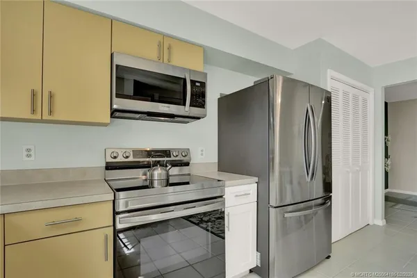 a kitchen with stainless steel appliances a refrigerator stove and microwave