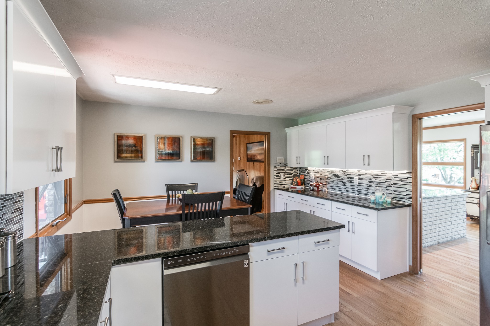 705 Ronnie Road Madison, TN 37115 - Photo 19 of 50 a kitchen with granite countertop a stove and white cabinets