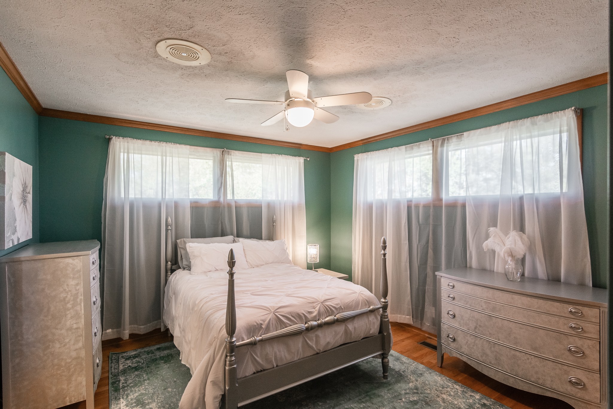 705 Ronnie Road Madison, TN 37115 - Photo 28 of 50 a bedroom with a large bed and a chandelier fan