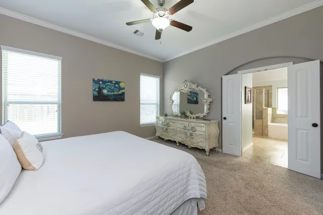 a bedroom with a large bed and a chandelier