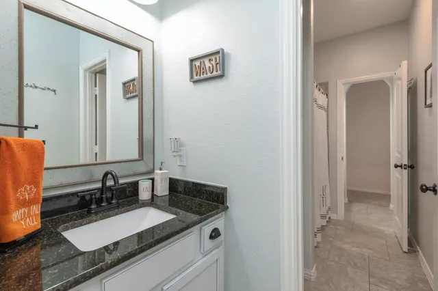a bathroom with a sink and a mirror