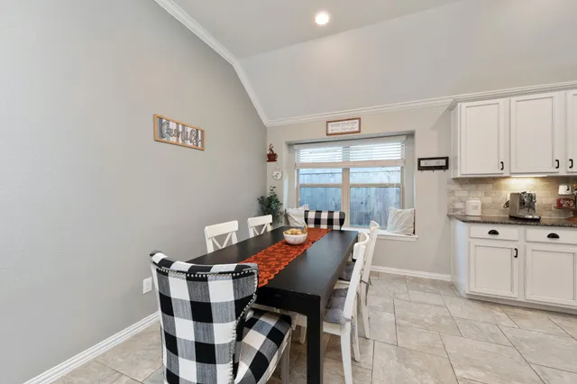 a view of a dining room with furniture and window