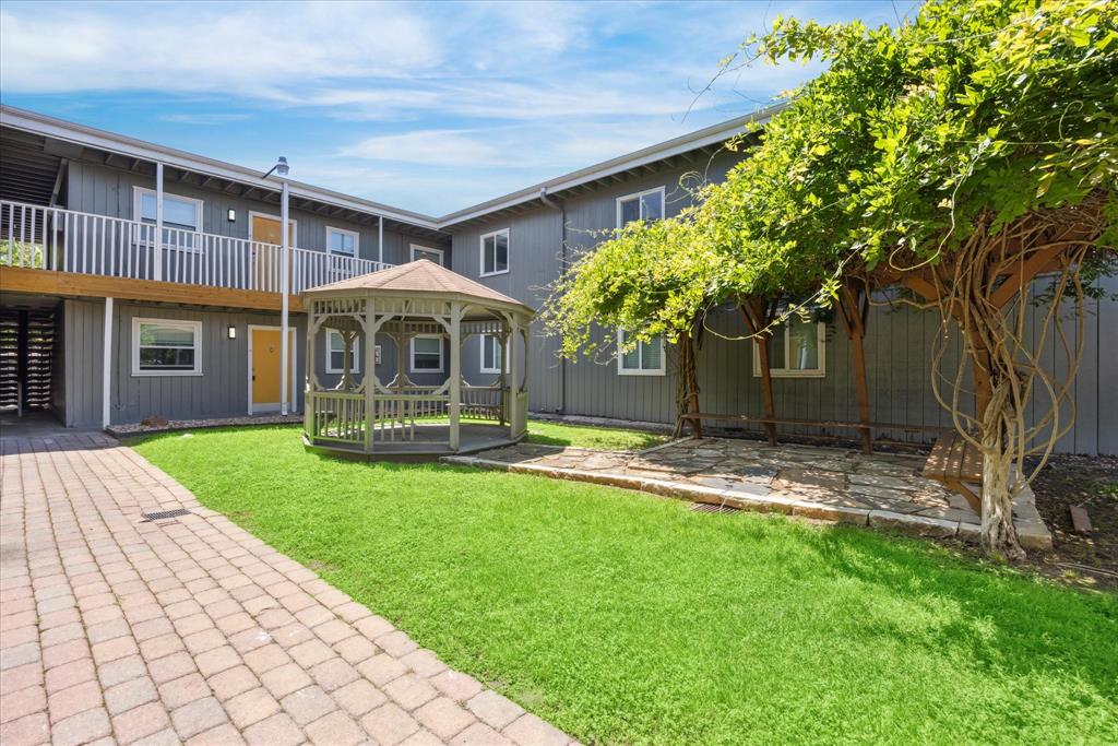 2401 Manor Road, Unit 232A Austin, TX 78722 - Photo 6 of 6 a front view of a house with a yard