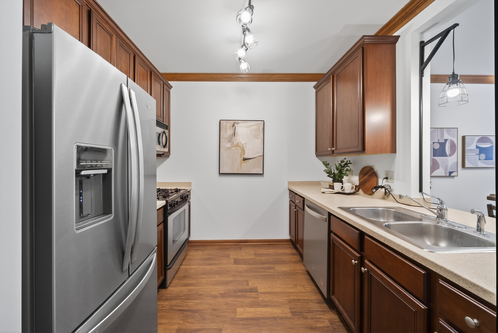 10 Ford Street, Unit 103 Geneva, IL 60134 - Photo 10 of 18 a kitchen with granite countertop a refrigerator and a sink