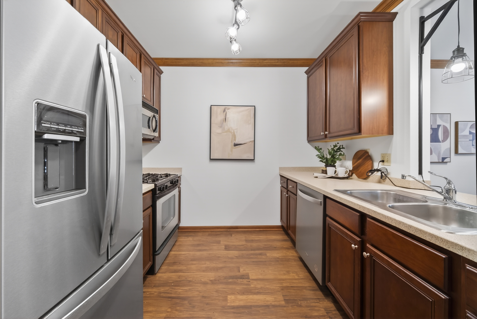 10 Ford Street, Unit 103 Geneva, IL 60134 - Photo 12 of 18 a kitchen with stainless steel appliances granite countertop a refrigerator and a sink