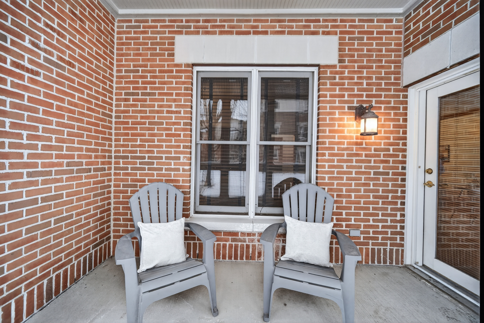 10 Ford Street, Unit 103 Geneva, IL 60134 - Photo 18 of 18 a view of a patio with a table and chairs