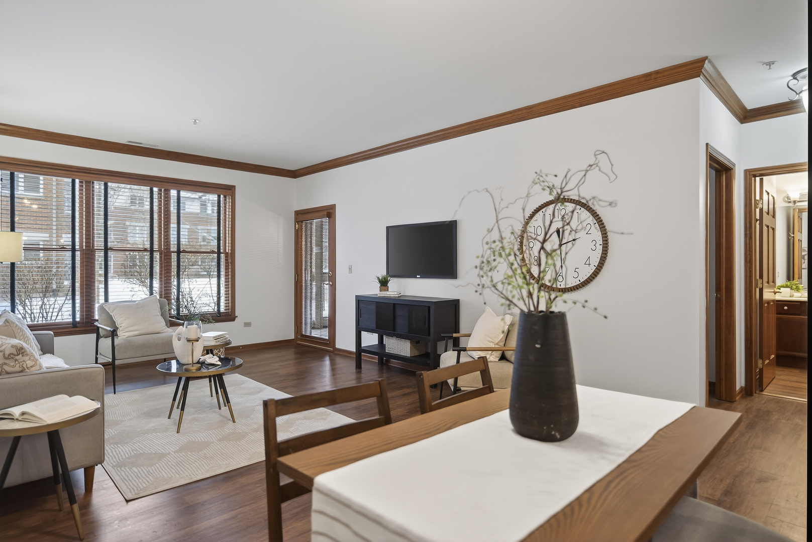 10 Ford Street, Unit 103 Geneva, IL 60134 - Photo 2 of 18 a living room with furniture a large window and flat screen tv