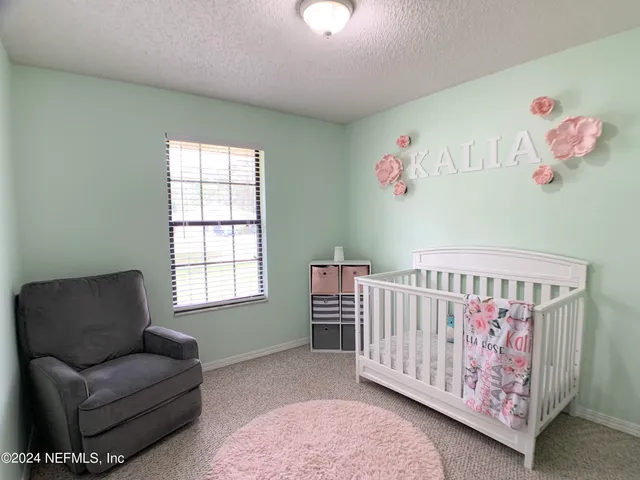 a bedroom with furniture and a window