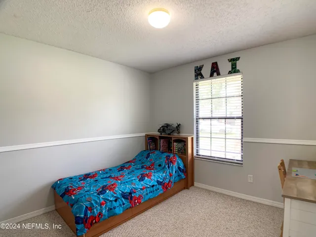 a bedroom with furniture and a window