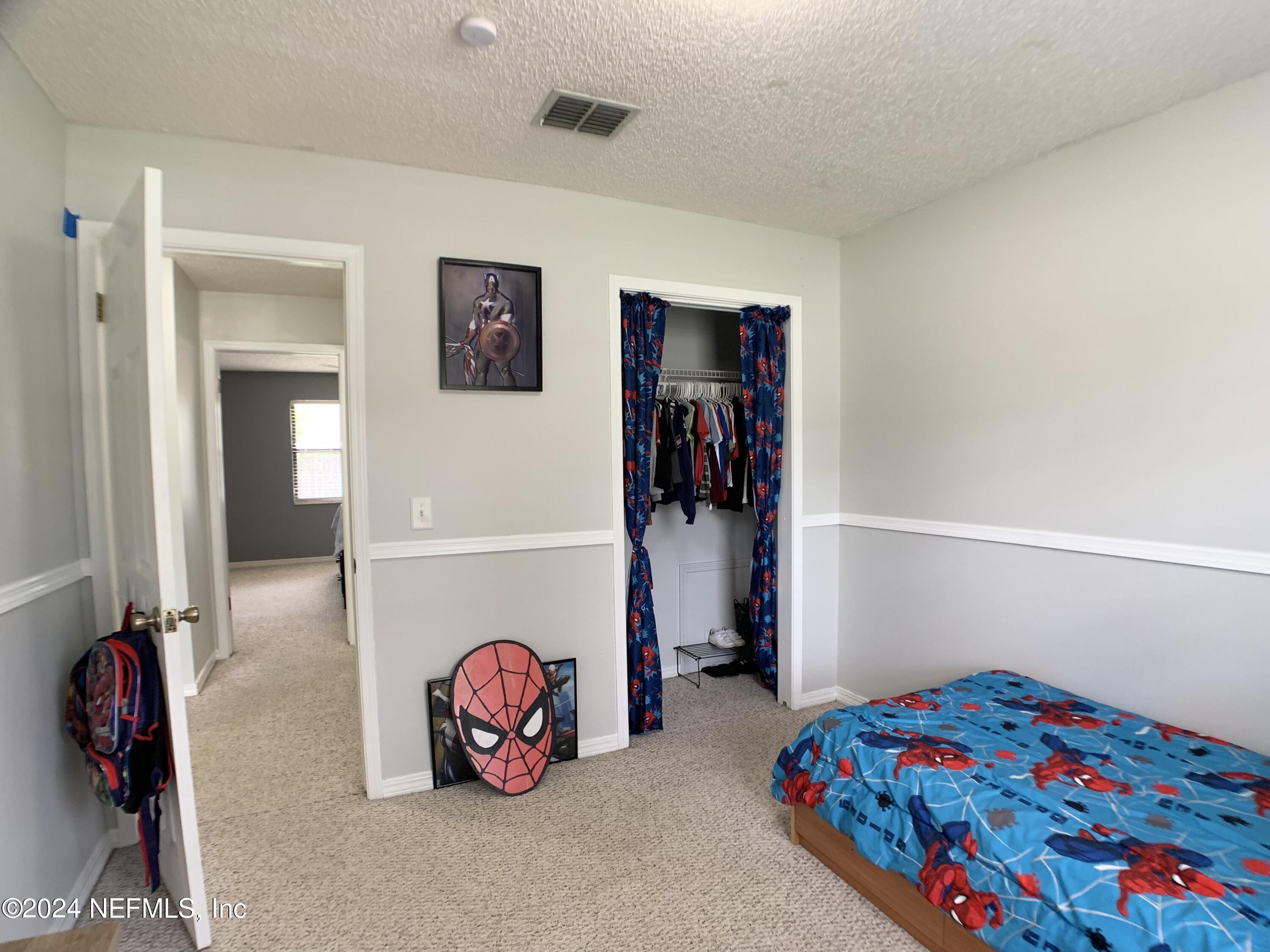 3149 Lakeside Villa Road Orange Park, FL 32073 - Photo 18 of 42 a bedroom with a bed and a window