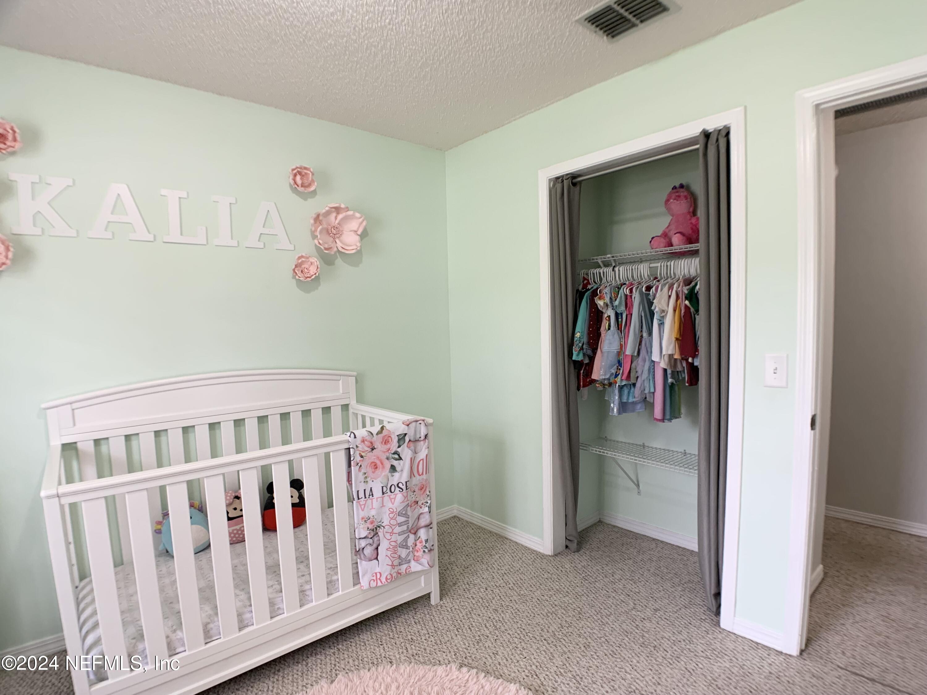 3149 Lakeside Villa Road Orange Park, FL 32073 - Photo 19 of 42 a bedroom with furniture and a window