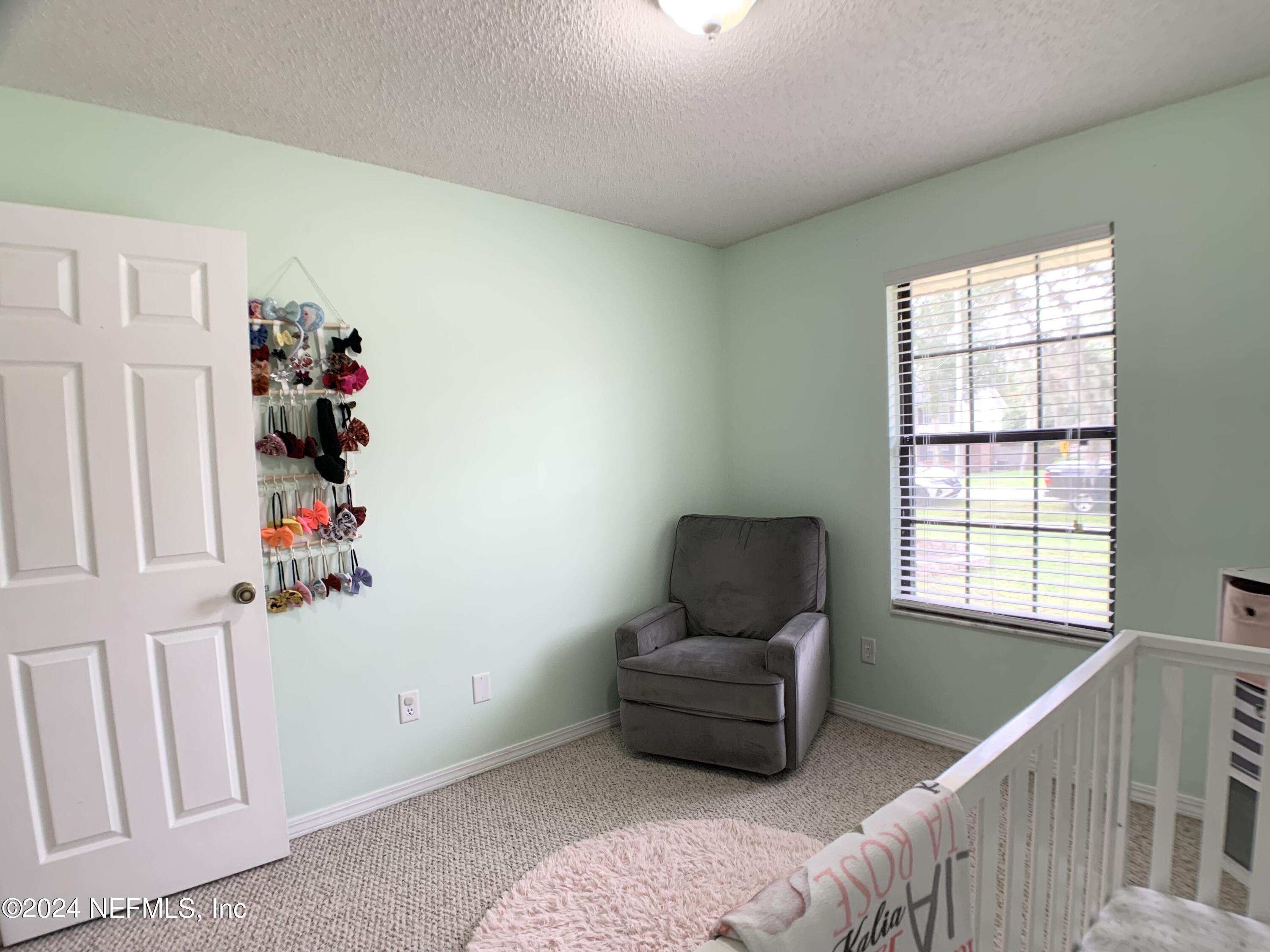 3149 Lakeside Villa Road Orange Park, FL 32073 - Photo 20 of 42 a living room with furniture and a window