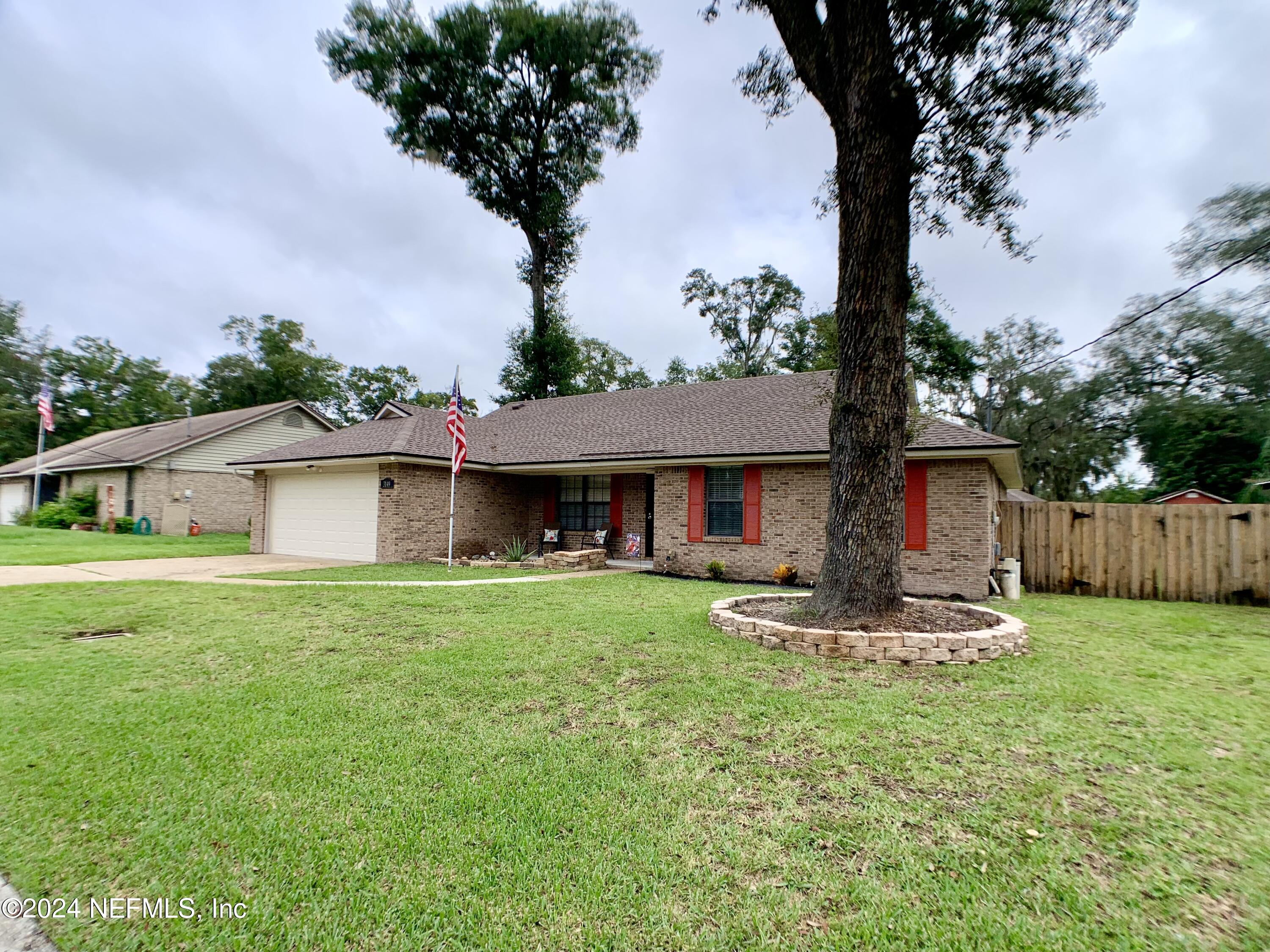 3149 Lakeside Villa Road Orange Park, FL 32073 - Photo 2 of 42 a front view of a house with garden