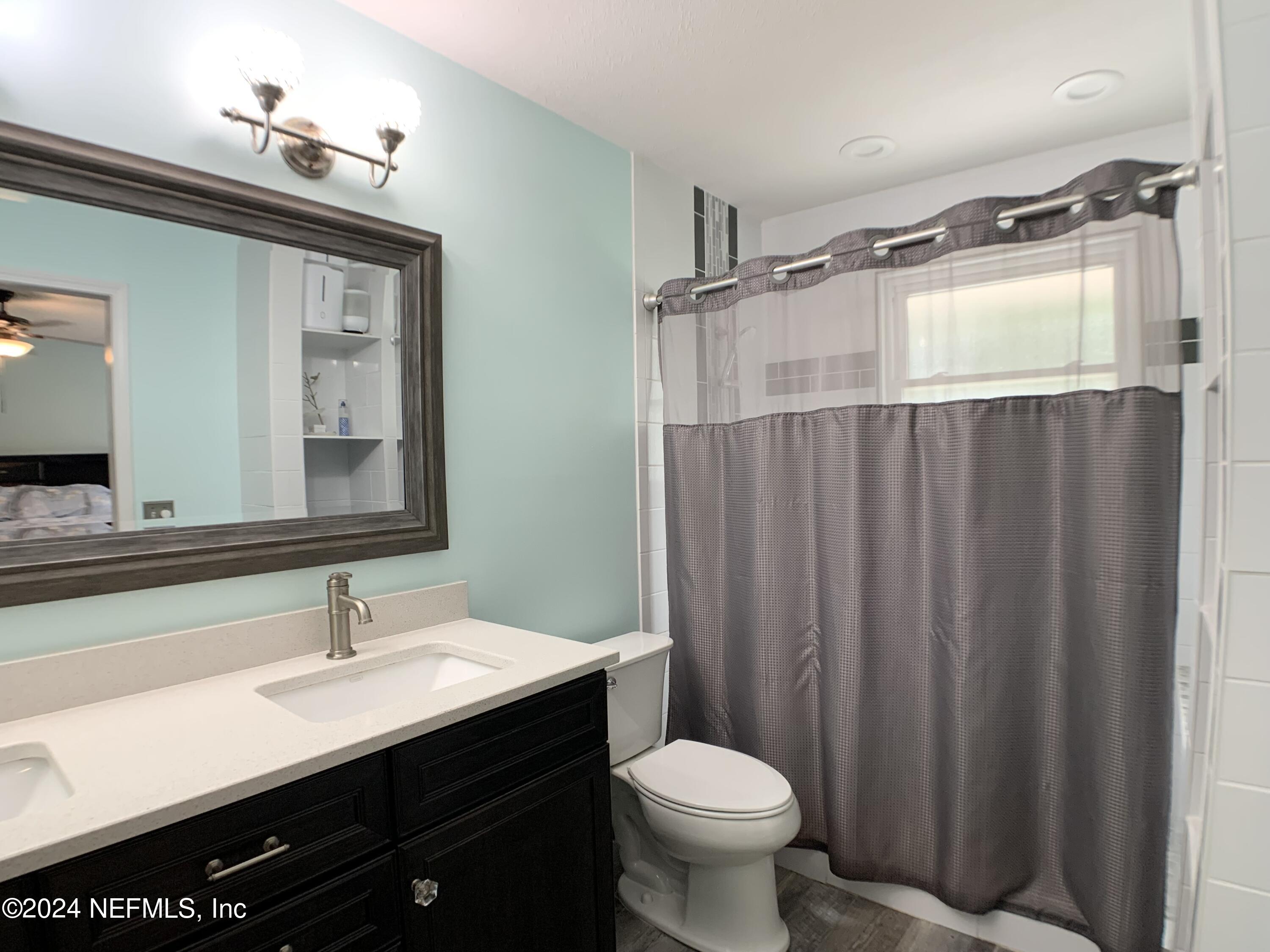 3149 Lakeside Villa Road Orange Park, FL 32073 - Photo 26 of 42 a bathroom with a sink and a mirror