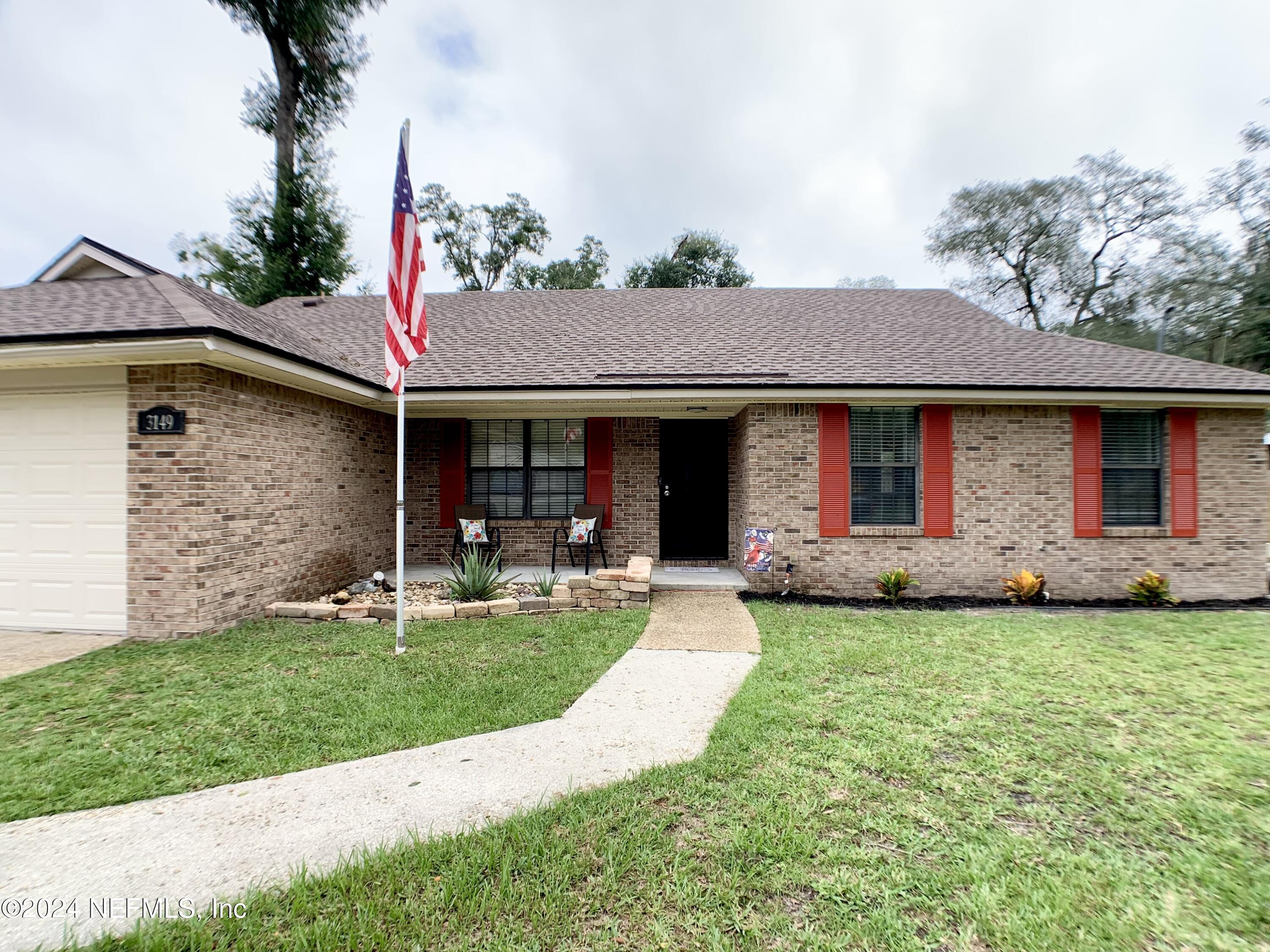 3149 Lakeside Villa Road Orange Park, FL 32073 - Photo 3 of 42 a front view of a house with garden