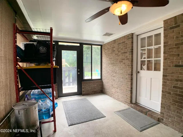 a view of a room with window and chandelier