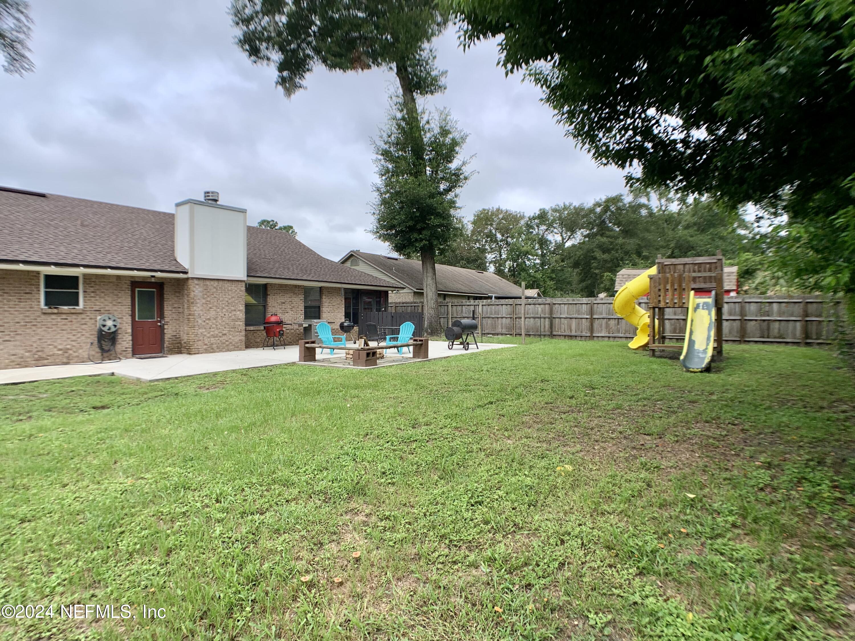 3149 Lakeside Villa Road Orange Park, FL 32073 - Photo 39 of 42 a view of a house with backyard and a tree