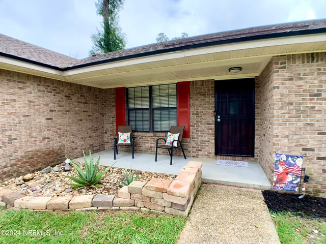a view of two chairs in patio of the house