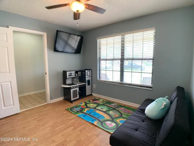 a bedroom with furniture and a window