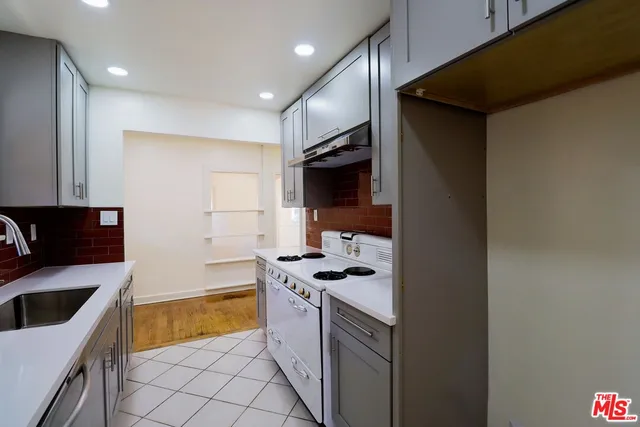 a kitchen with a sink stove and refrigerator